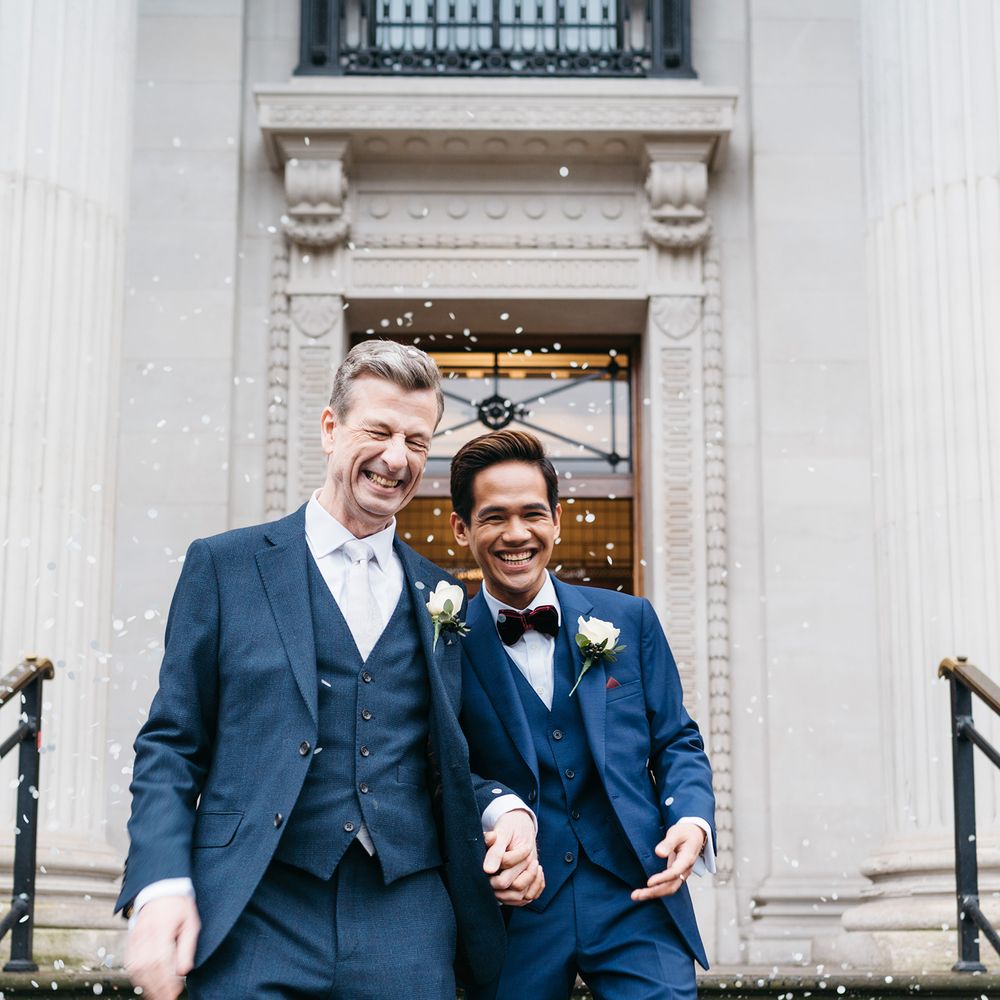 Grooms after wedding ceremony on the steps of Old Marylebone Town Hall