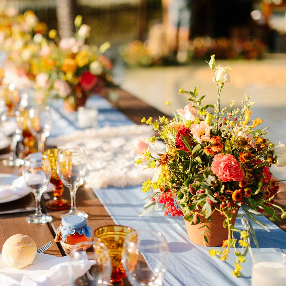 Terracotta pots filled with plants as minimal table centrepieces for a destination wedding in Greece