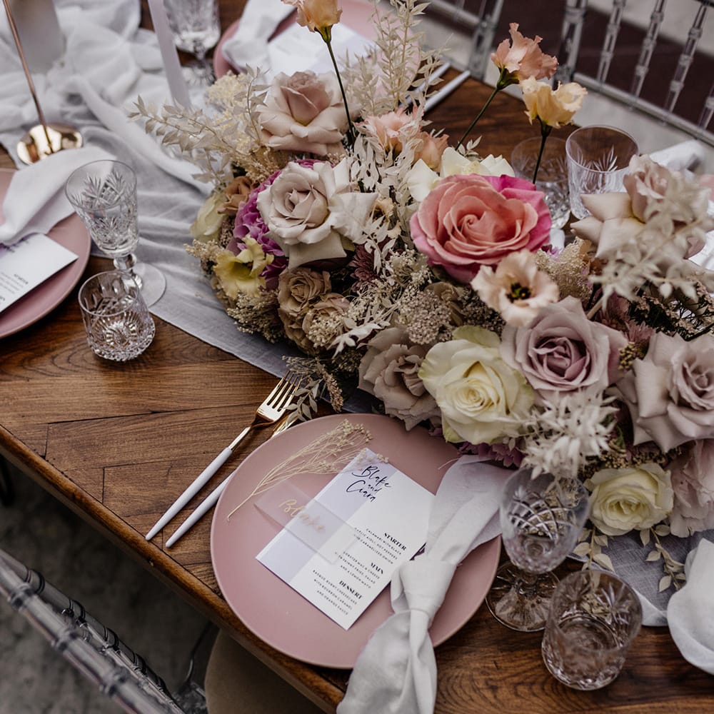 Place setting with pink tableware, cut glass, perspex table name ad menu card 