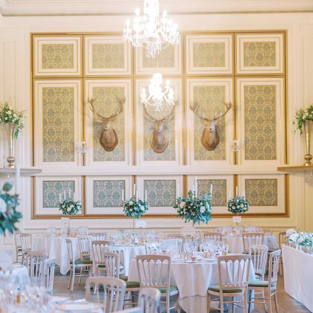 wedding reception at Drumtochty Castle with white and green flowers and gold cutlery 