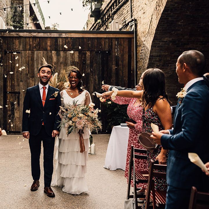Black bride and groom descending up the aisle as husband and wife after their 100 Barrington wedding ceremony 