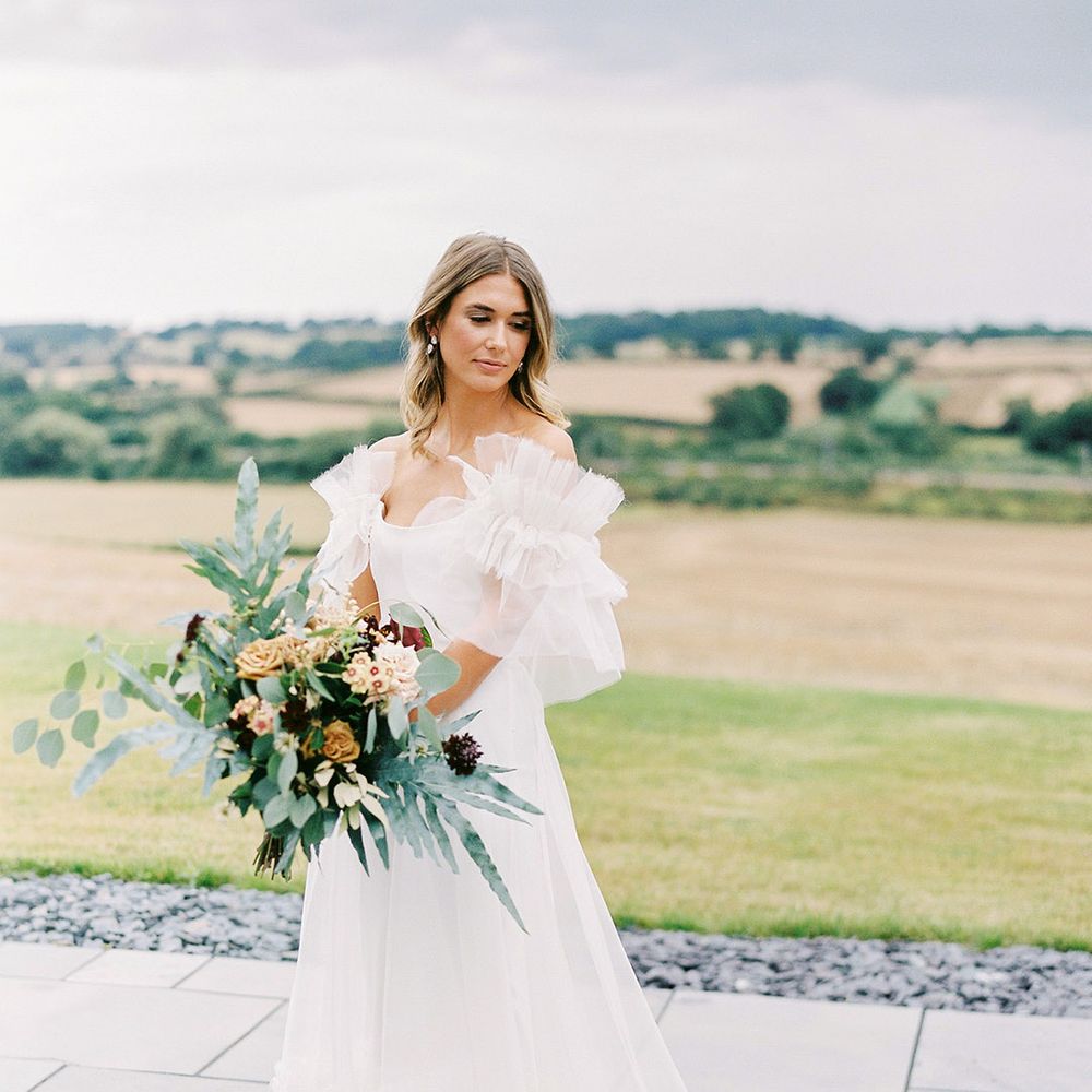 Bride in Halfpenny London wedding dress with ruffle sleeves