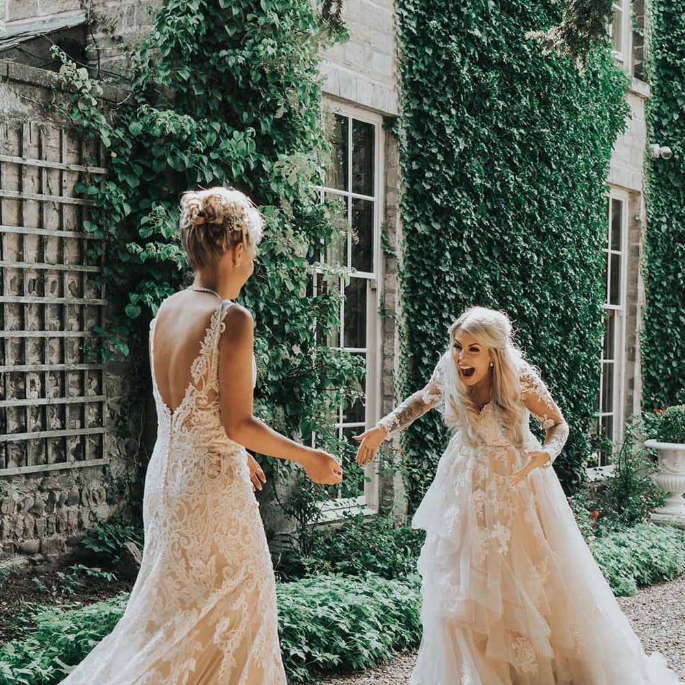 Couple engage in a 'first look' before their wedding ceremony, laughing with mouths open