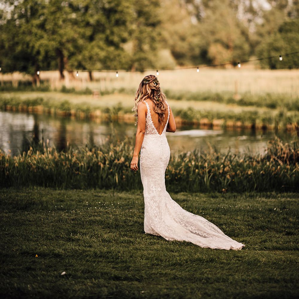 Bride in lace wedding dress with button detail