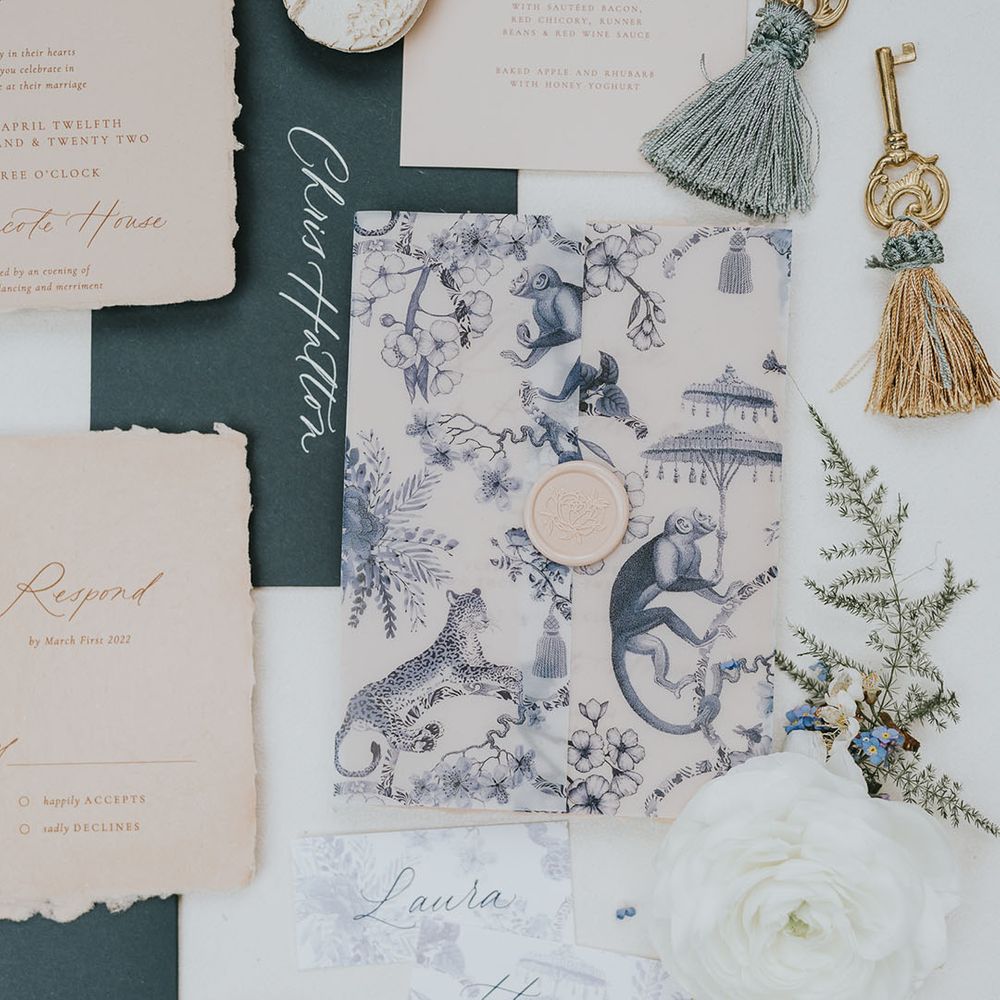 Blue and white wedding stationery envelope with aged wedding invitation, RSVP and menu 