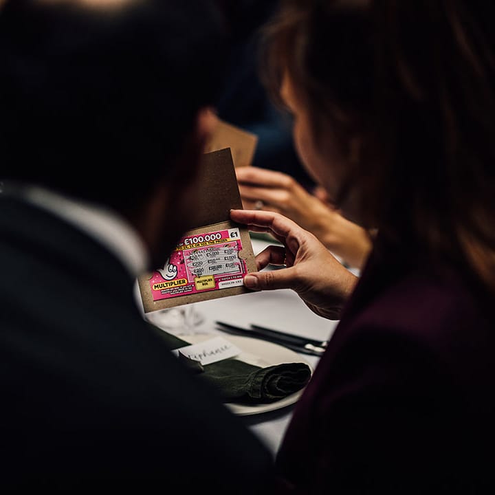 Guests open their lottery ticket wedding favours 
