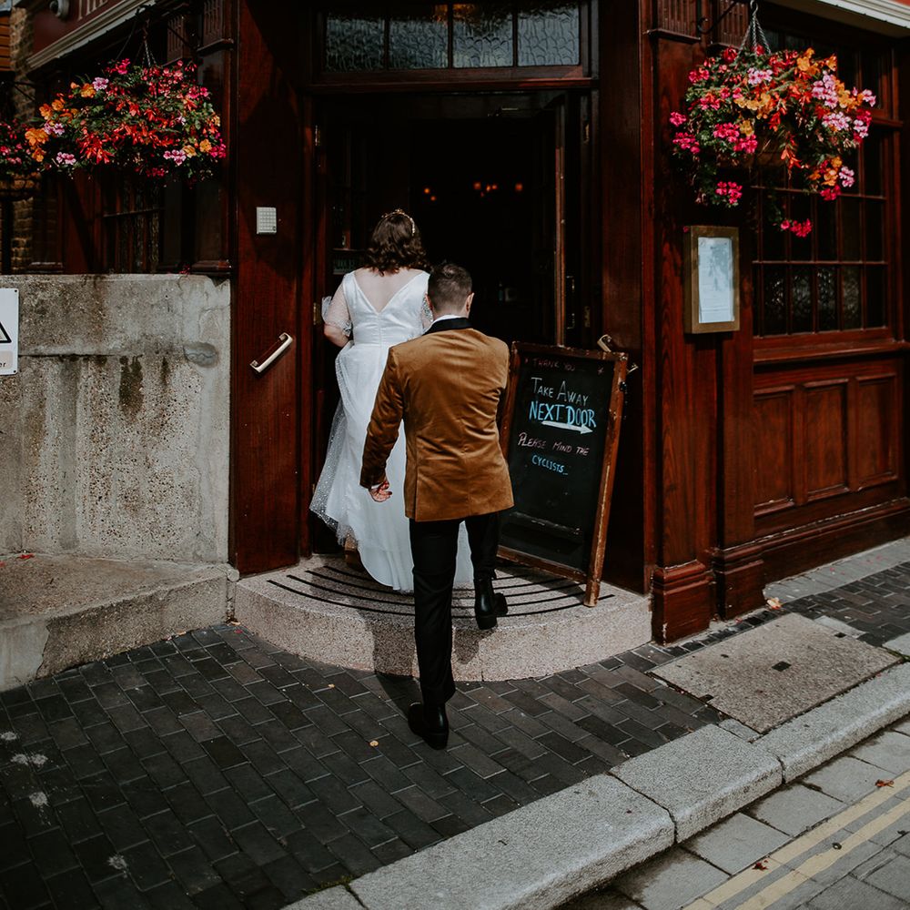 Bride and Groom enter wedding reception at pub venue