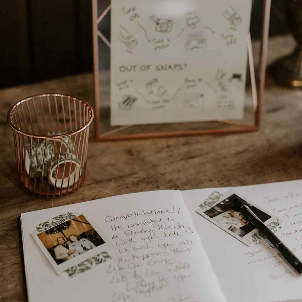 Wedding guest book with polaroid photos and golden framed wedding guestbook sign 