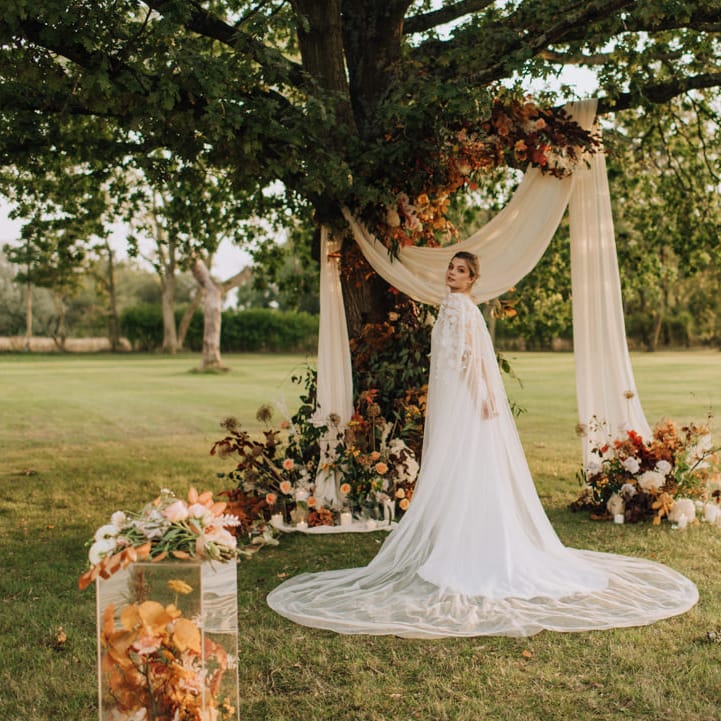 Bride at golden hour in outdoor Reymerston Hall ceremony