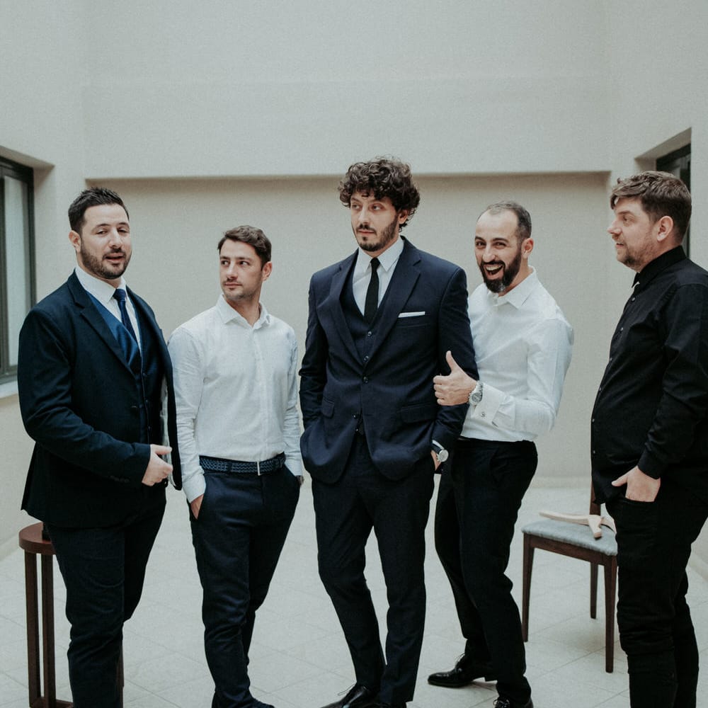 The groom and groomsmen getting ready in Mi Ro suits
