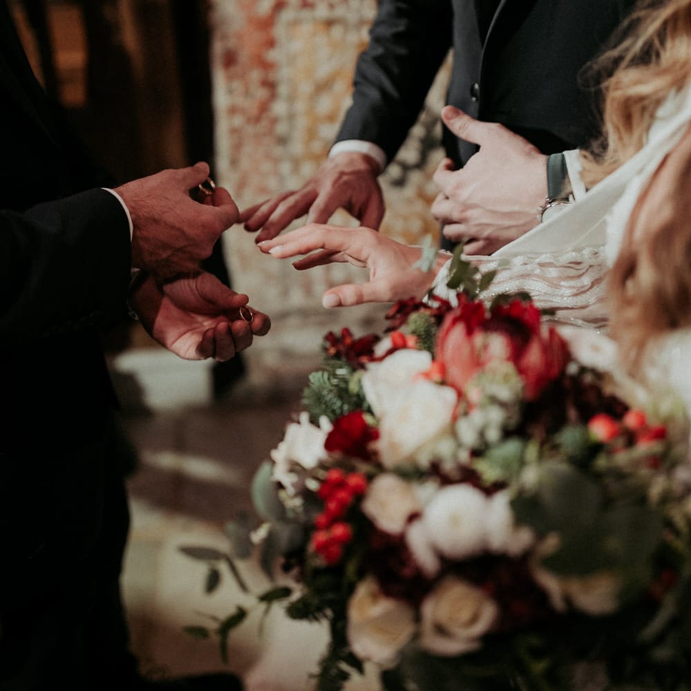 Exchanging wedding rings at their church ceremony