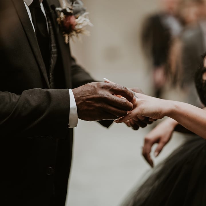 Bride & groom exchange wedding rings during ceremony
