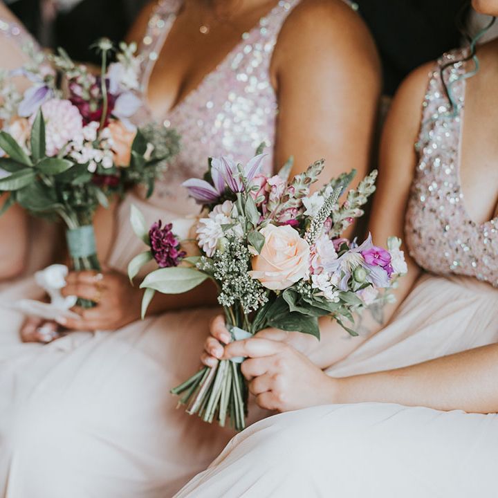 Purple, pink, orange, white wedding bouquets for bridesmaids with greenery