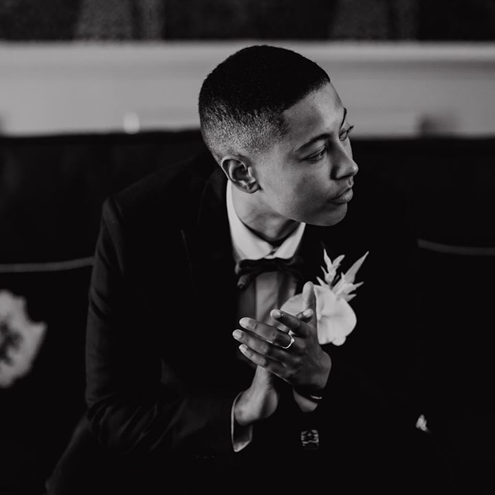 LGBTQI+ wedding inspiration with tuxedo and white orchid buttonhole flower 