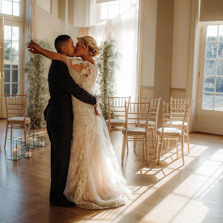 wedding ceremony room at Hodsock Priory with light flooding in the doors, drapes and gypsophila column flowers 