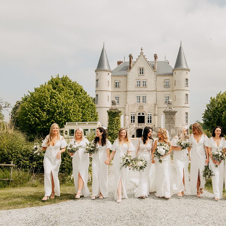 Bride party all in white with white flowers for classic chateau wedding 