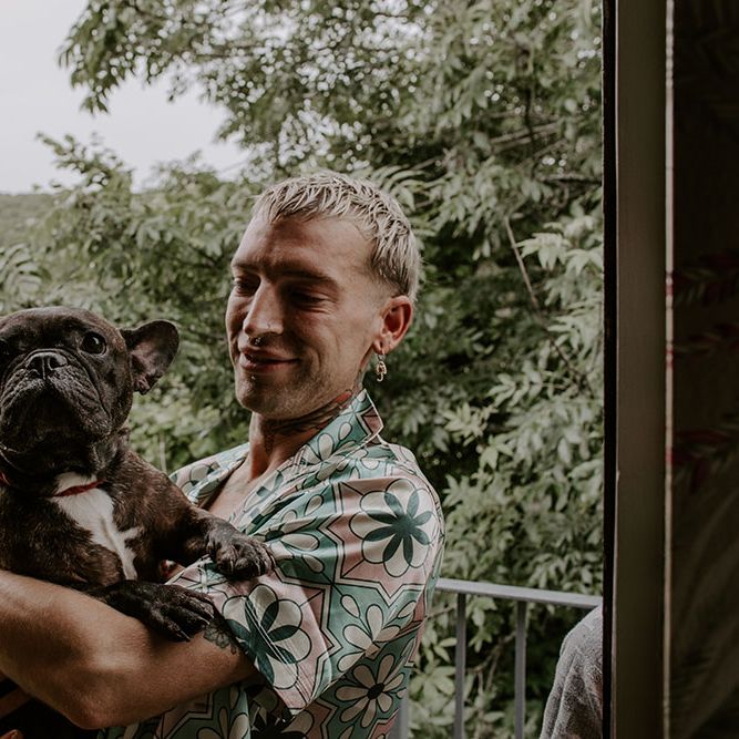 Groom carries his dog on the morning of his wedding day 