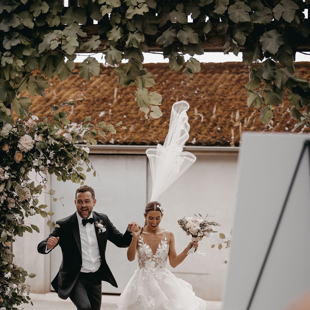 The bride and groom walk into their epic wedding reception 