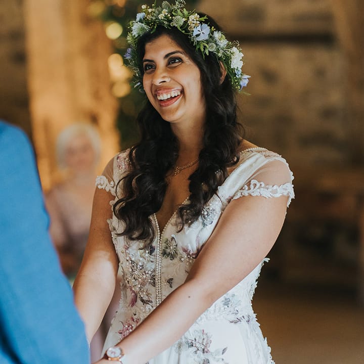 British Indian bride wearing a flower crown and Savin London Amelia dress