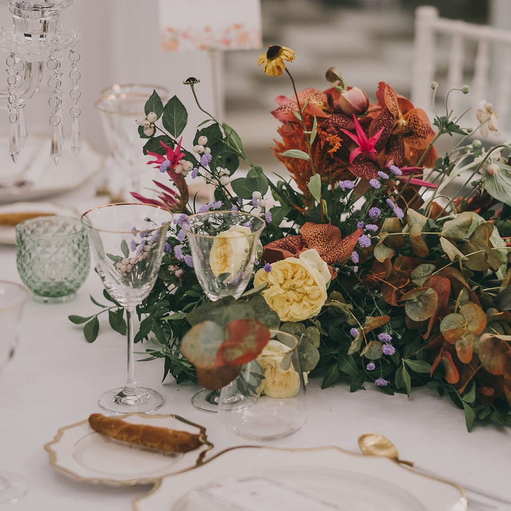 elegant wedding place setting with colourful flower centrepiece 
