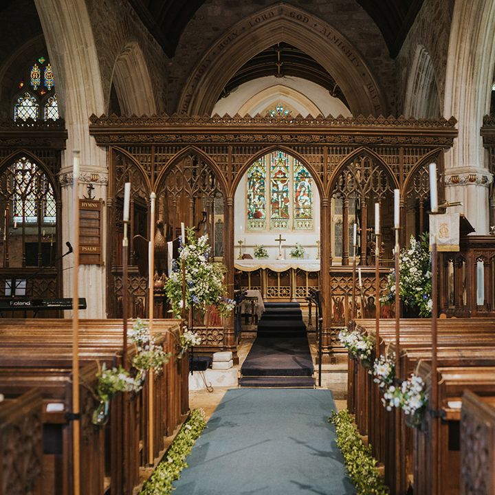 Church wedding ceremony with candles and daisy flower decor for a traditional Christian wedding 
