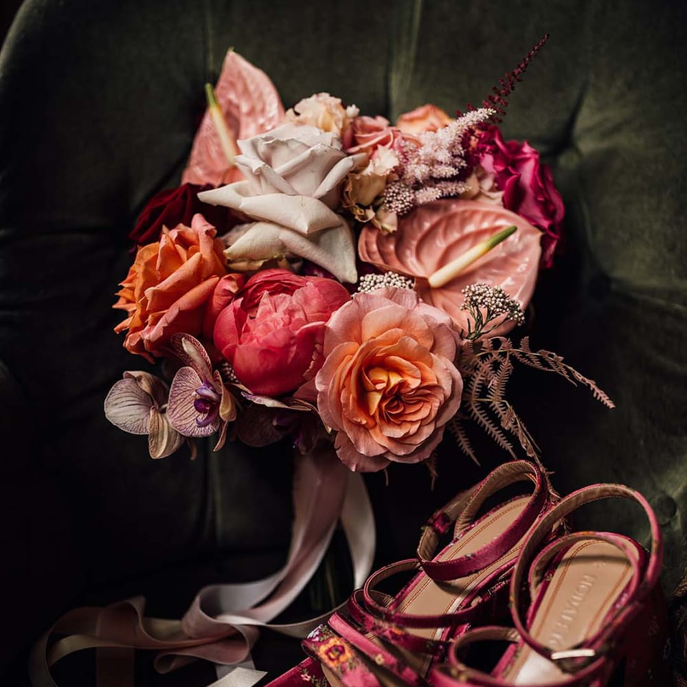 Bridal accessories for the pink theme wedding with pink wedding bouquet of anthuriums and roses and pink platform floral wedding shoes 