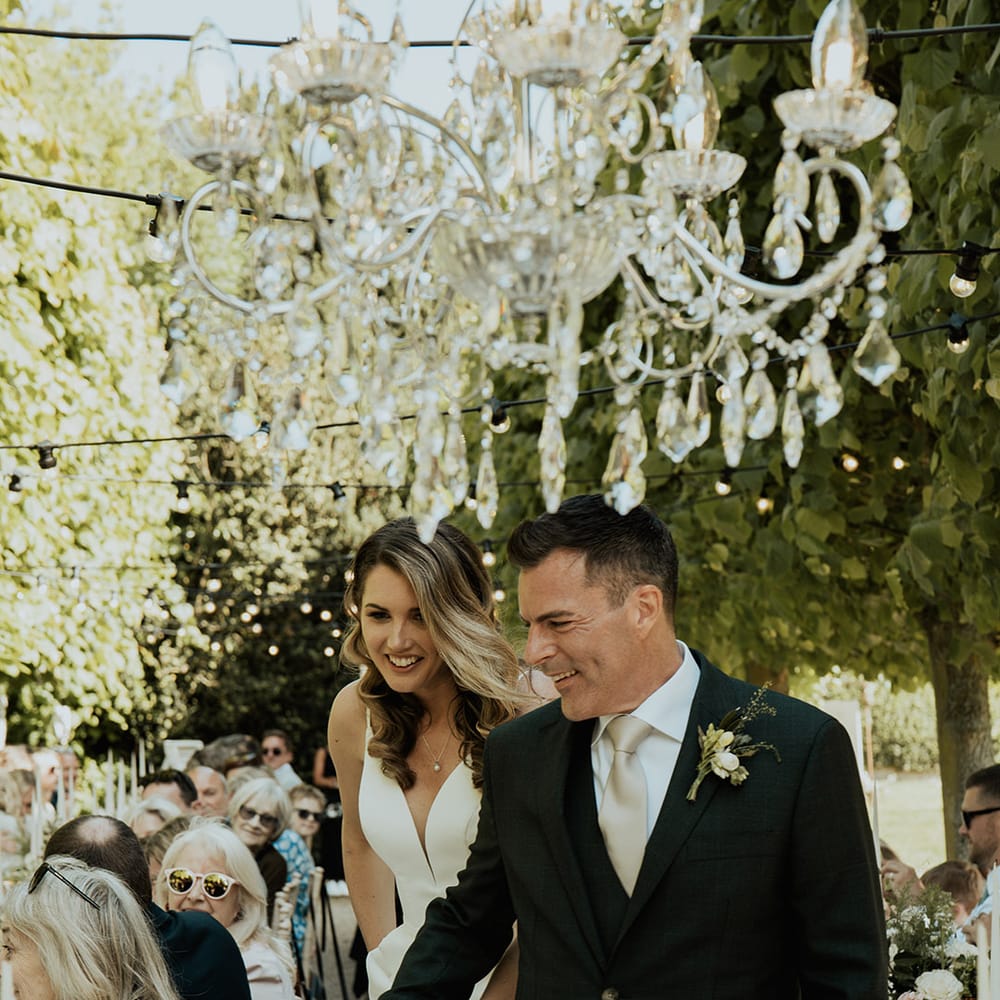 Al fresco outdoor wedding breakfast at Kelmarsh Hall and Gardens with crystal chandelier decorations