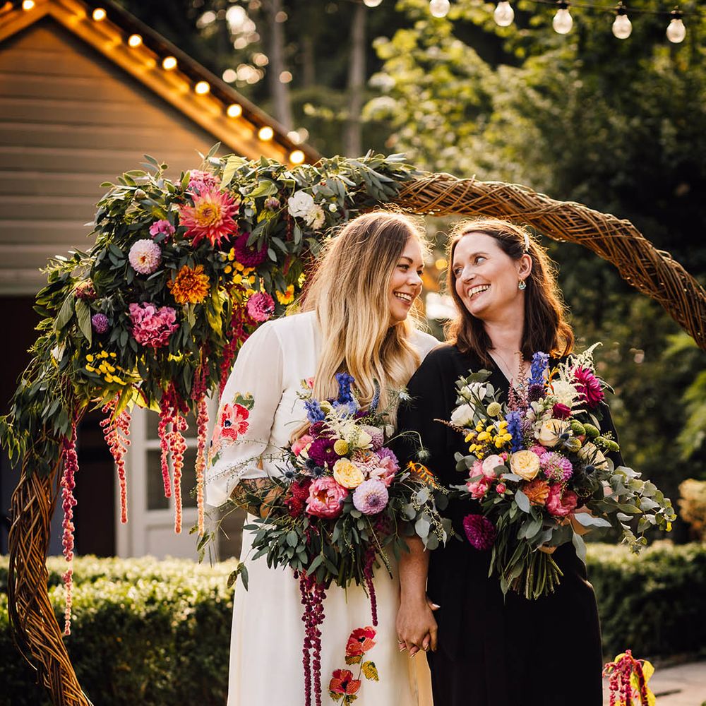 Boho moongate decoration moved to the outdoors to use as photo backdrop for the two brides at their same sex wedding 