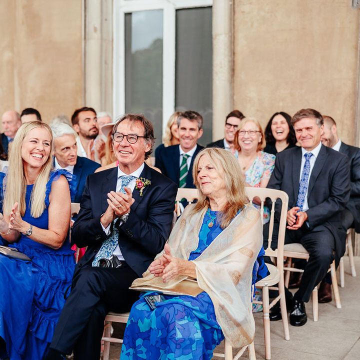 Wedding guests wearing bright blue outfits at wedding 