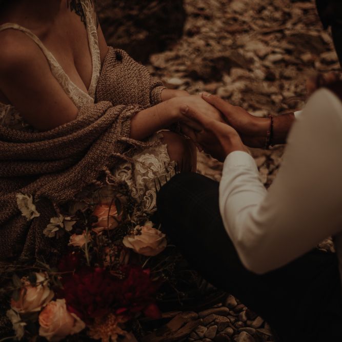 Bride and groom holding hands at intimate beach elopement