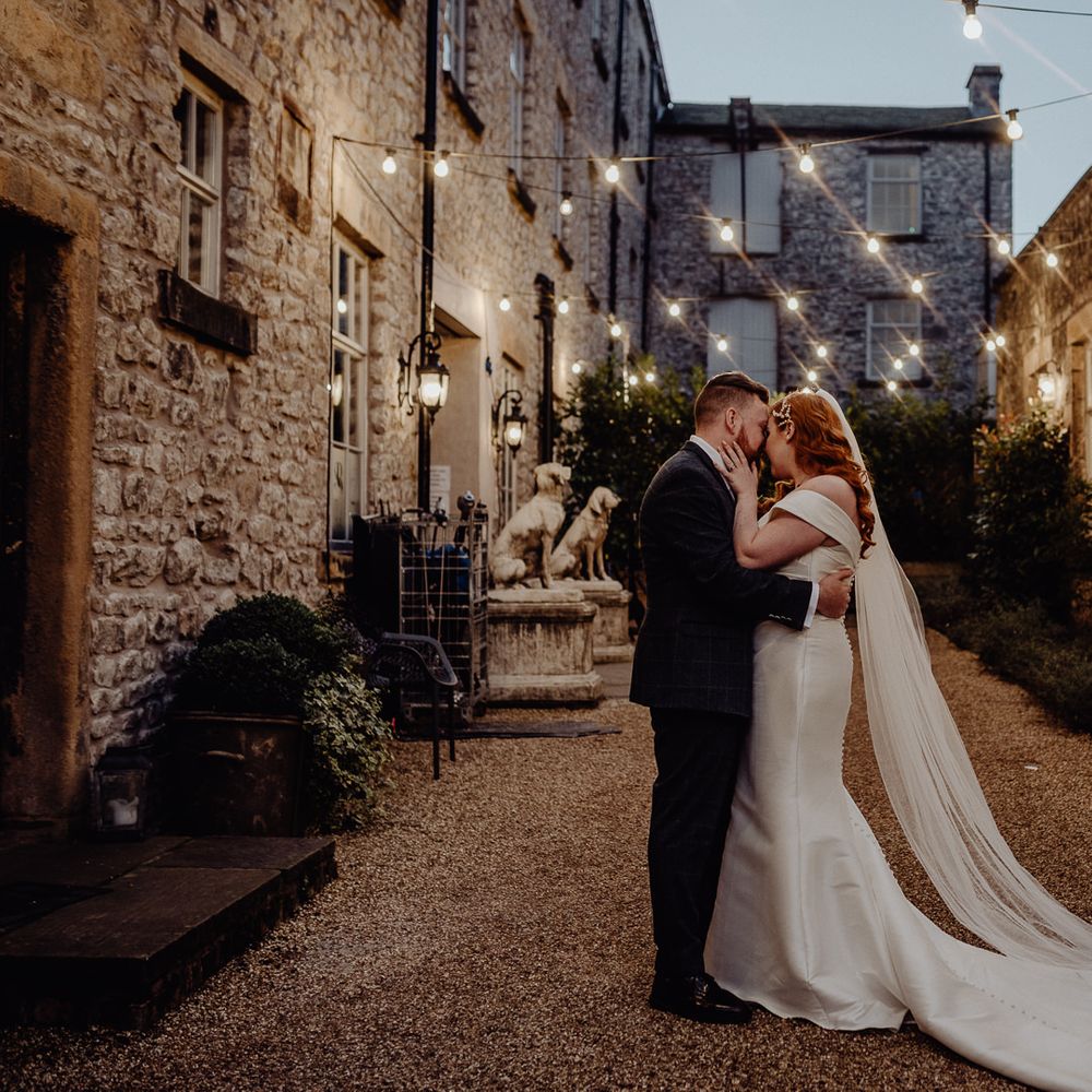 Bride and groom portrait in the courtyard at Holmes Mill by Louise Griffin Photography