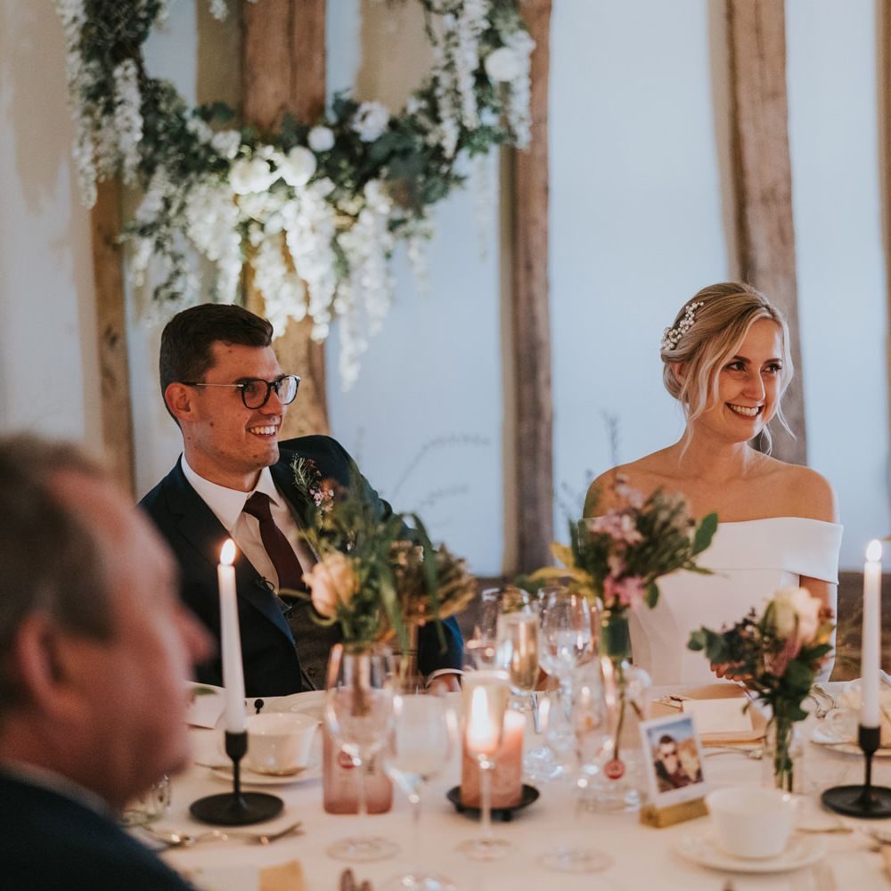 Bride & groom laugh during reception 