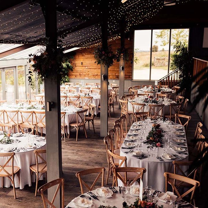 Stone Barn Cotswolds wedding with fairy light ceiling decor 