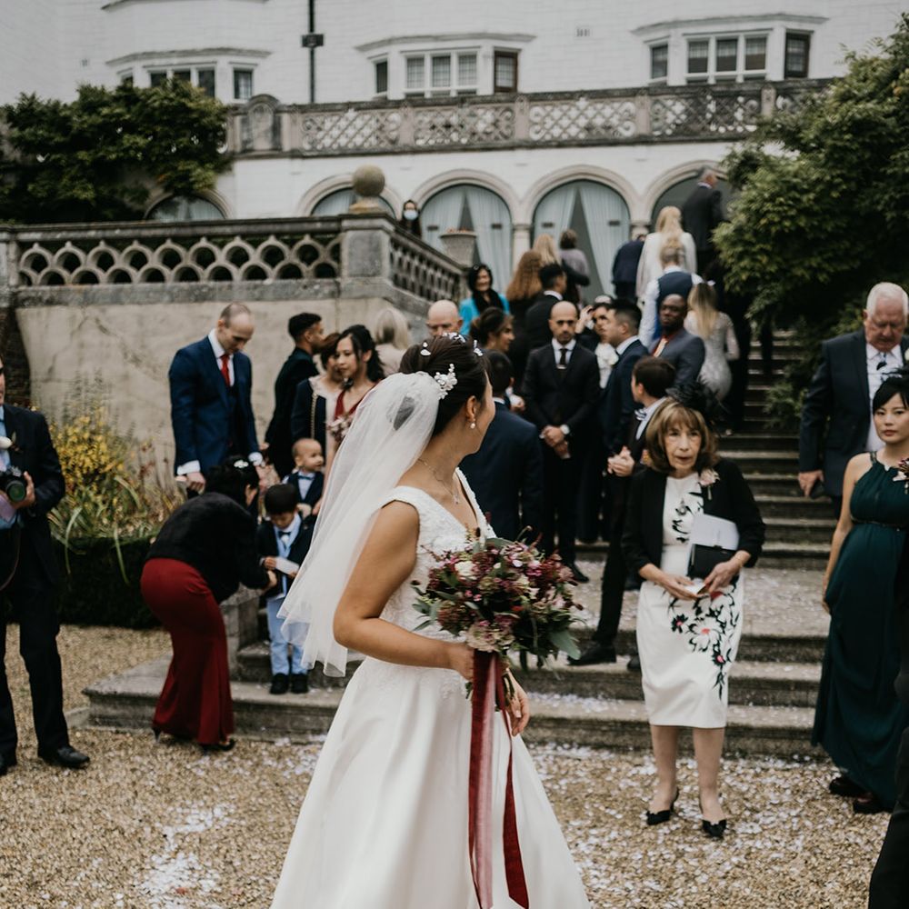 Bride clutches burgundy bouquet 