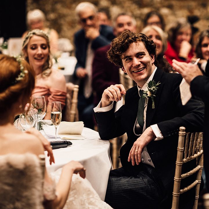 Bride and groom enjoy wedding speeches