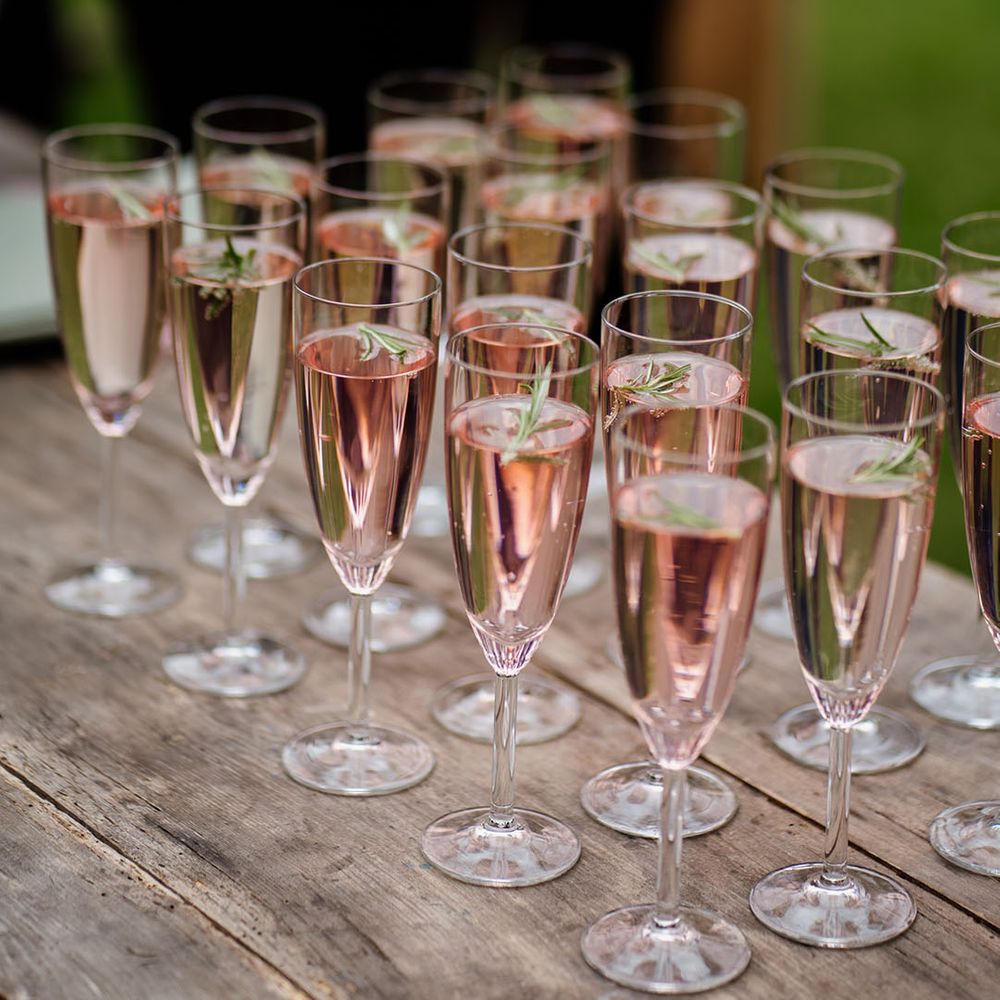 Champagne glasses full of drinks for wedding guests 