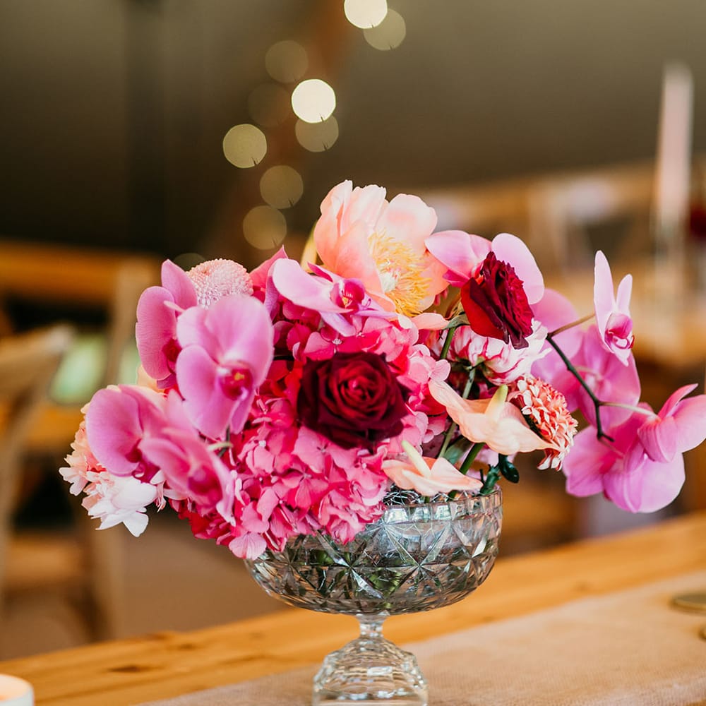Orchid, roses and hydrangeas with pink and red wedding flowers 
