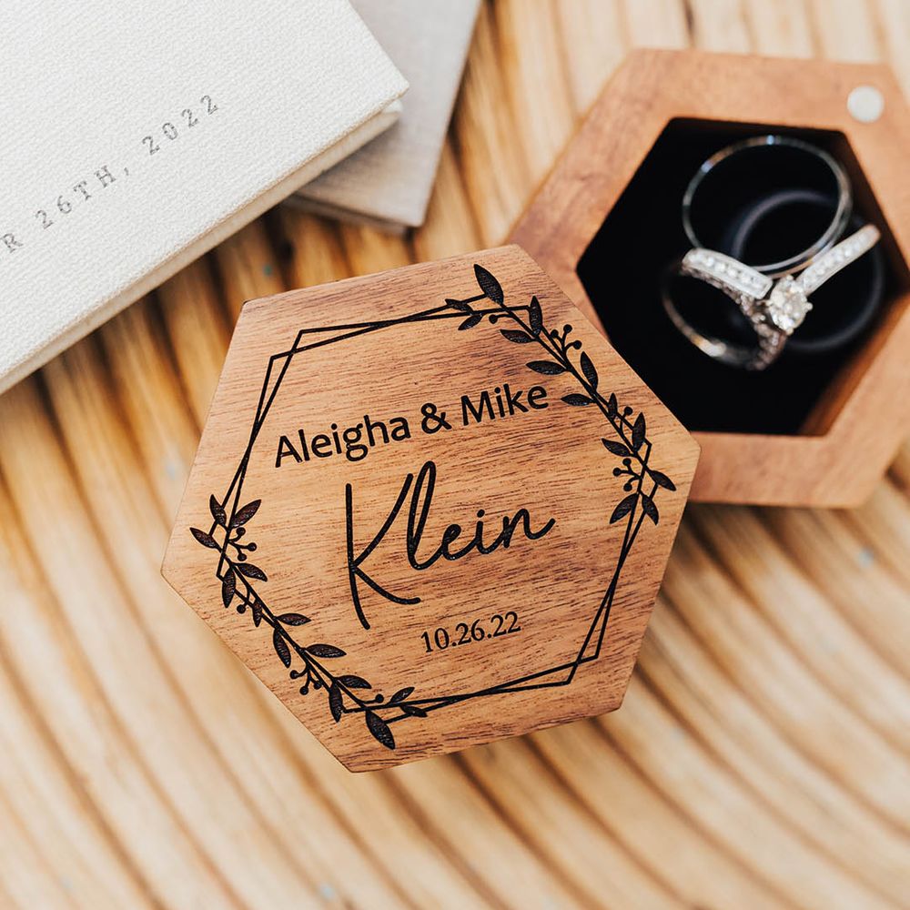 Personalised wooden custom ring box with the bride and groom's wedding bands inside 