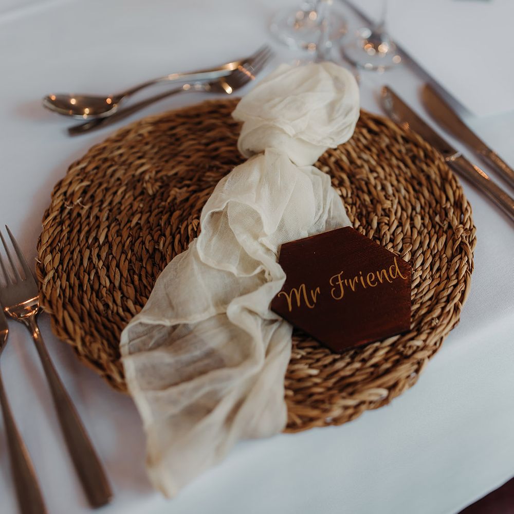 Wicker place mat with sheer napkin and custom made wedding place name for the autumnal wedding 