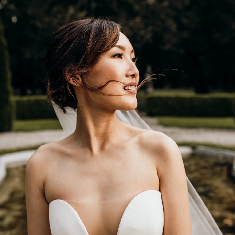Beautiful Asian bride with natural makeup and strapless wedding dress with sheer element 