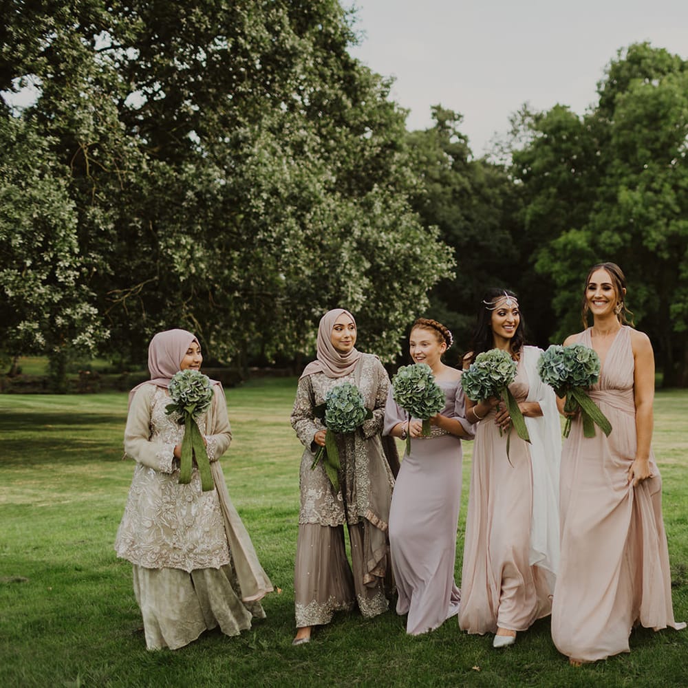 Bridesmaids in pastel dresses and saris'