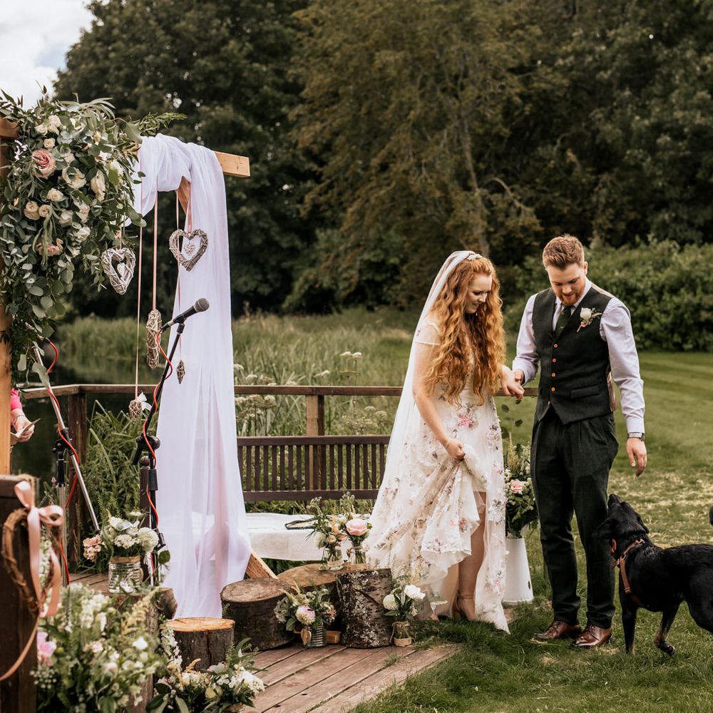 Bride & groom at Houghton Lodge Gardens with black Labrador 