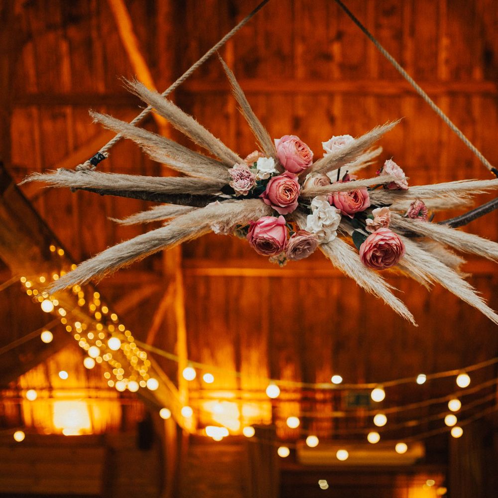 Pampas grass cloud with white and pink roses at Tythe Barn Wedding with boho decor