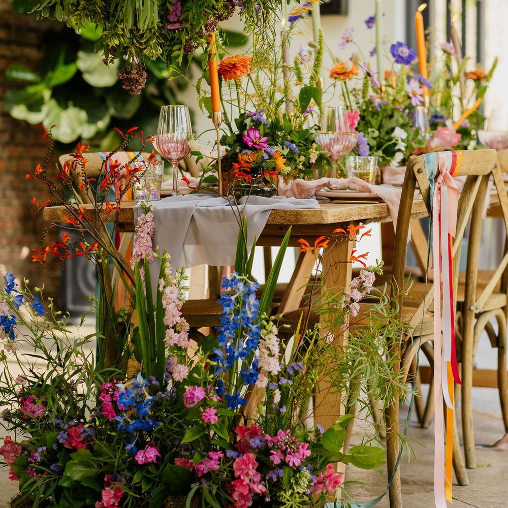 Colourful wildflower wedding decoration with installations, table end flowers and centrepieces 