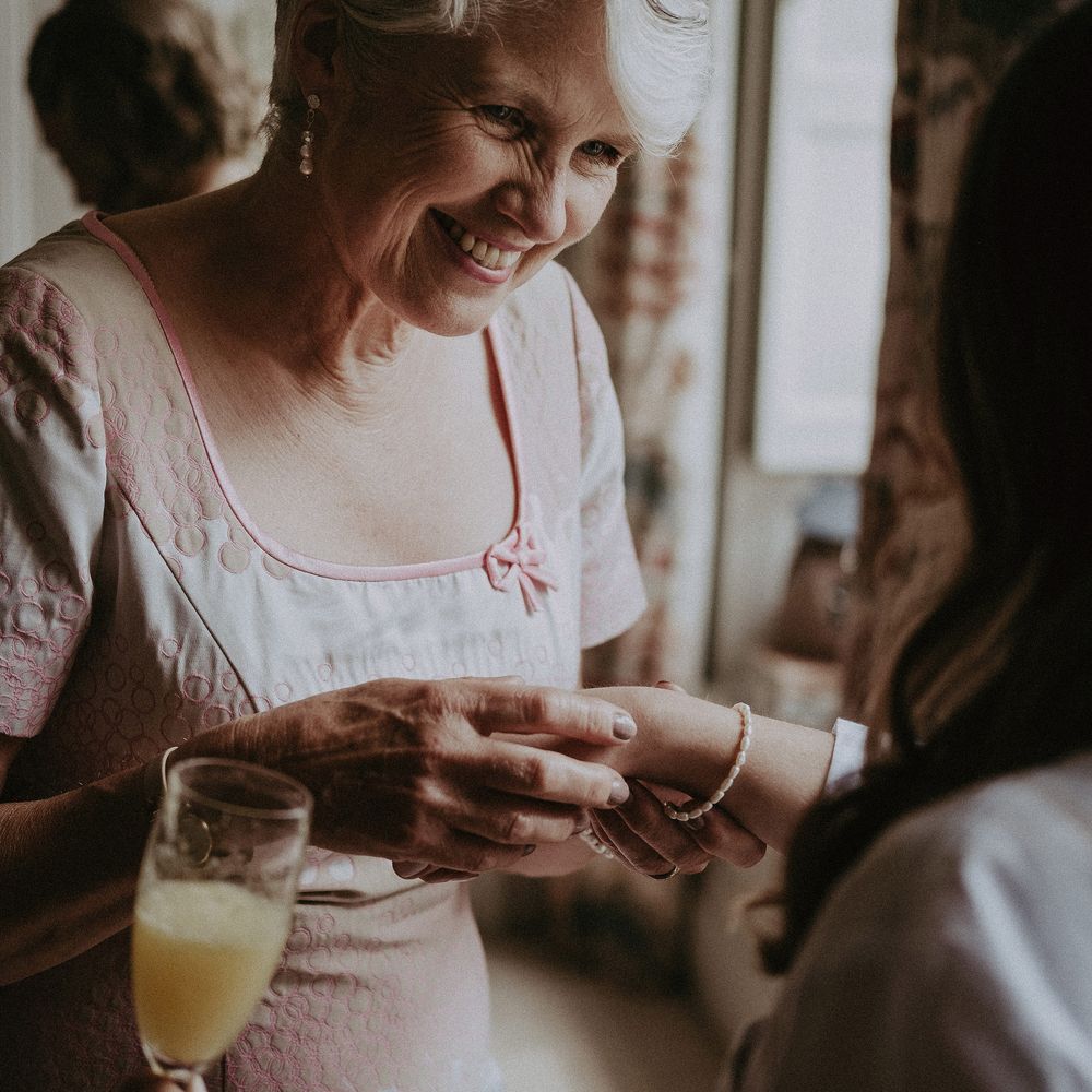 Mother of the bride on the morning of wedding admires brides bracelet