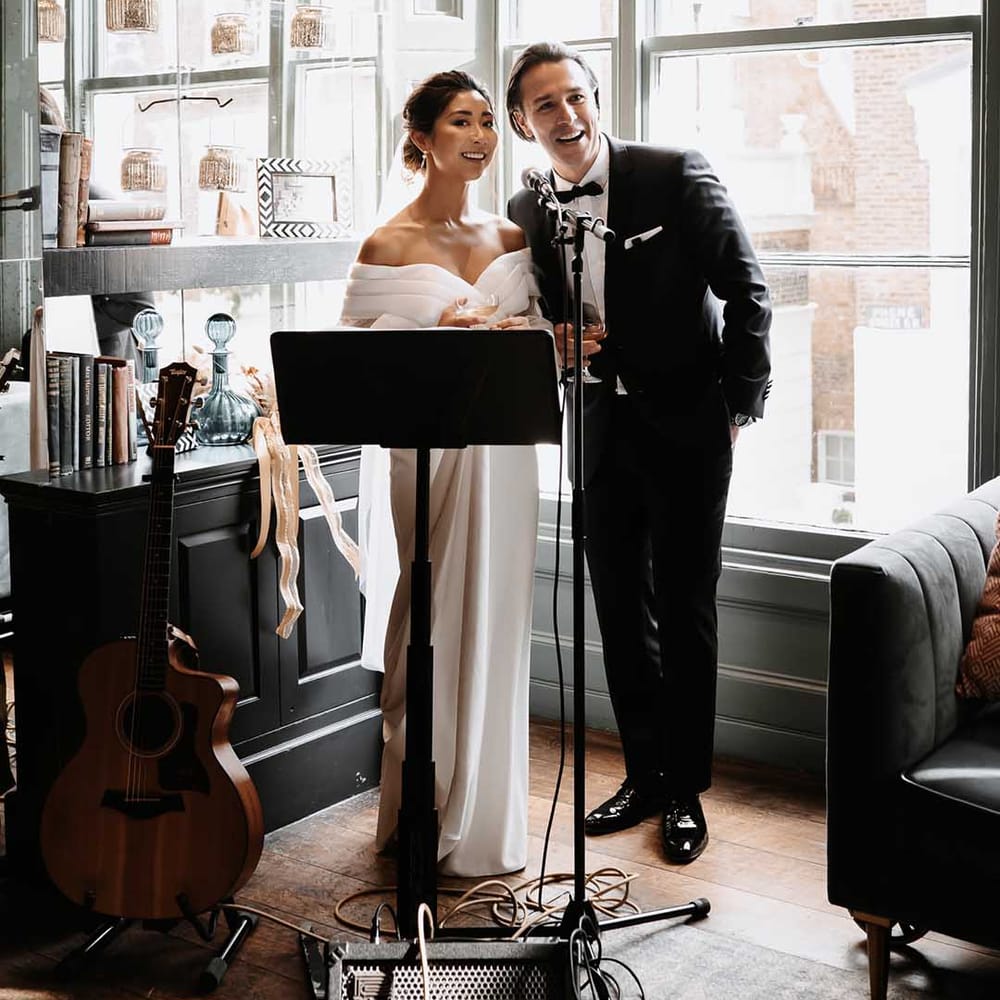 Groom and Bride speak to guests in chiq surroundings in London venue 