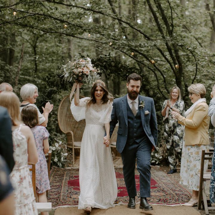 Bride & groom walk together through the woodland after wedding ceremony at The Dreys 