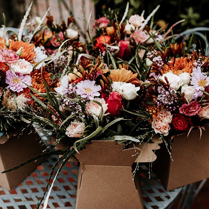 Bouquets of warm tones wedding flowers for rustic autumnal wedding at Silchester Farm