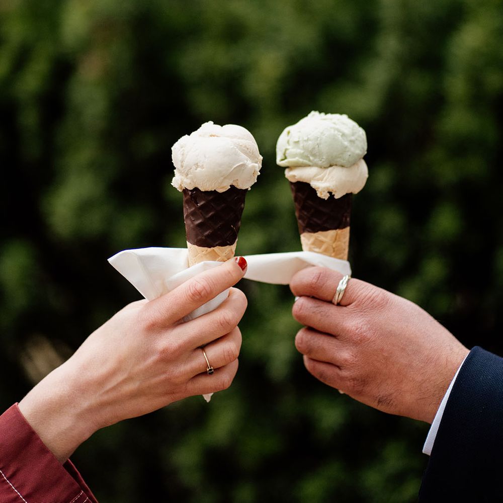Wedding guests eat an ice cream from the ice cream van at the wedding 
