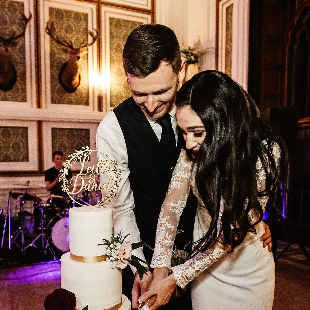 Bride & groom cut wedding cake during traditional Persian knife dance 